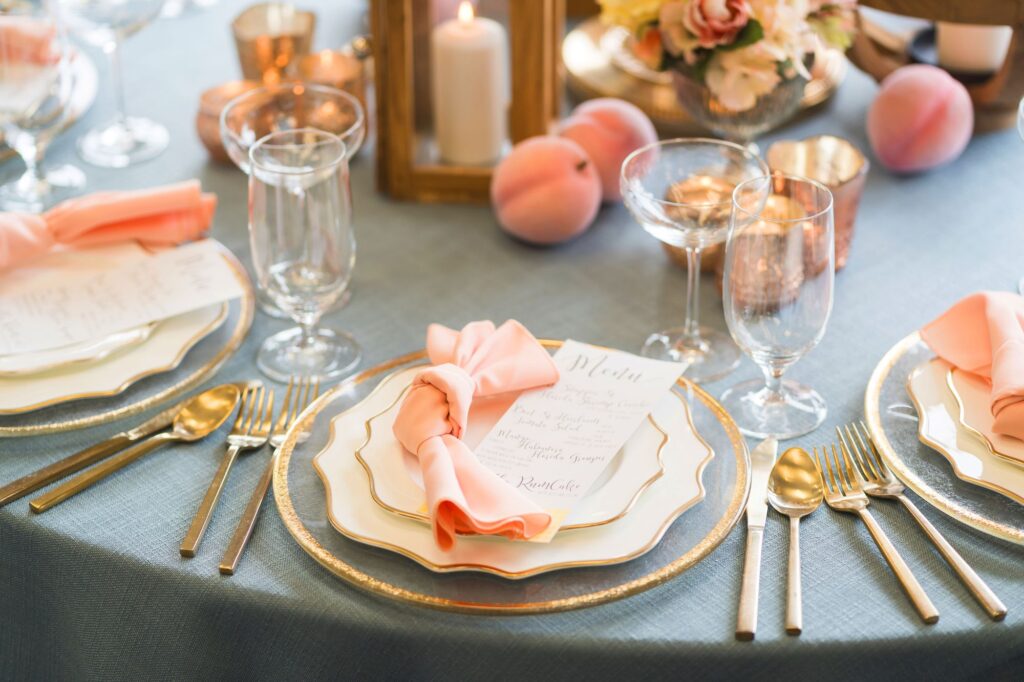 Wedding reception table setting with rented linens, napkins and gold accents by GBS Linens